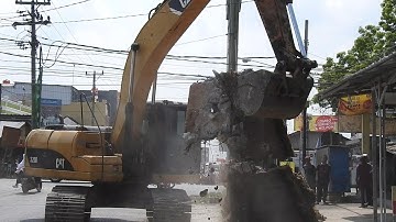 CAT Excavator 320D Working Digging Soil and breaking Concrete For New Water Tunnel Contructions