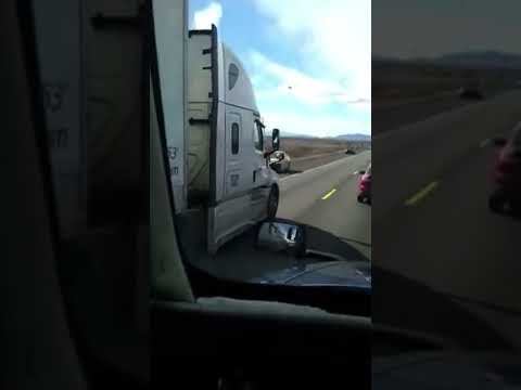 Swift Transportation driver passes on a 2 lane road forcing oncoming cars onto the shoulder