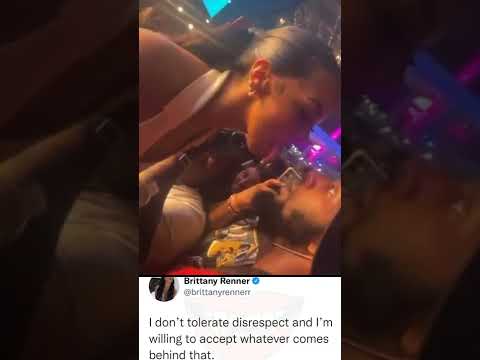 Brittany Renner and concert goer throw water on each other