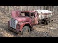 Abandoned trucks in woods in America. Abandoned pickup in USA. Abandoned semi truck