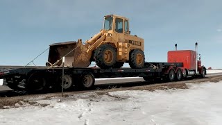 buying a front end loader hauling it home