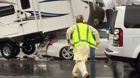 Car drives under RV trailer and Truck on  I-264 in...