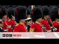 Troops perform royal salute in buckingham palace garden following king charles coronation  bbc news