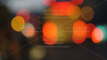 Colorful traffic lights bokeh circles on night city street. Abstract background