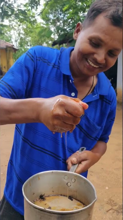 Babulal having Honey from the Flies collected from the woods
