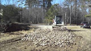 Compact Track Loader Spreading Stone