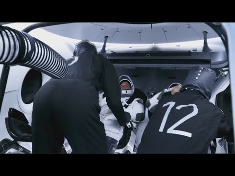 Astronauts strap into
