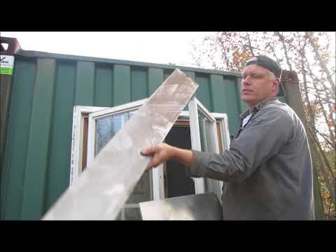 shipping container garage gets a window hacked in.