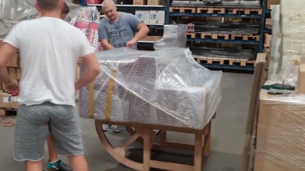 Video: an upright piano being packed and secured for transport abroad