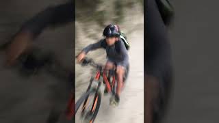 Boy rides bike on dirt trail then falls down ditch near river