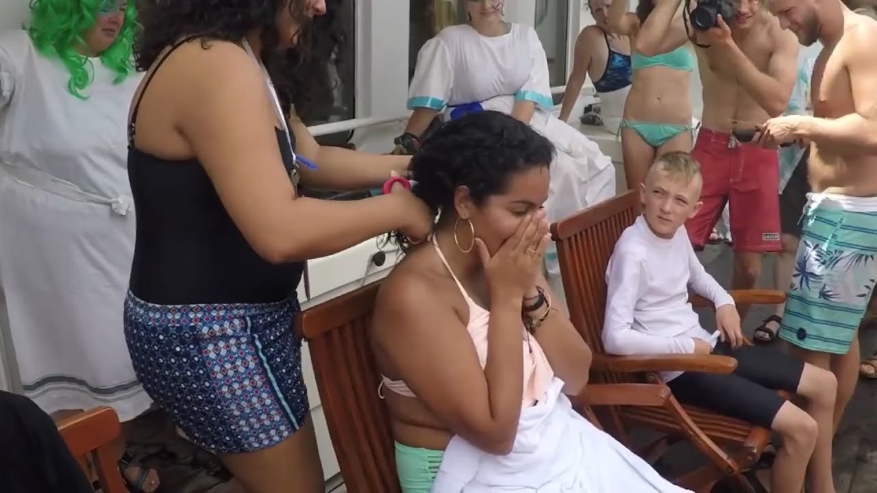 NEPTUNE DAY: young girls getting headshave for Neptune day in ocean cruise