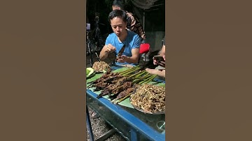 Ngươi đàn ông ăn cá lóc nướng . 구운 생선을 먹는 남자