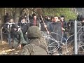 Heightened tensions on polandbelarus border as migrants attempt to force down border fence