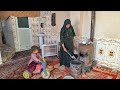 Pregnant nomadic woman struggles to clean her sheep's house
