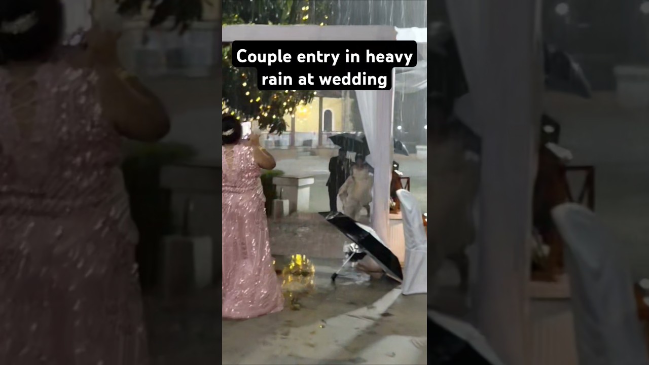 COUPLE ENTRY IN HEAVY RAIN AT GOAN WEDDING
