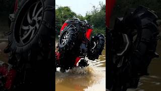 Honda on 40 inch SuperATV nators walking a water wheelie at AMP honda atv wheelie offroad mud