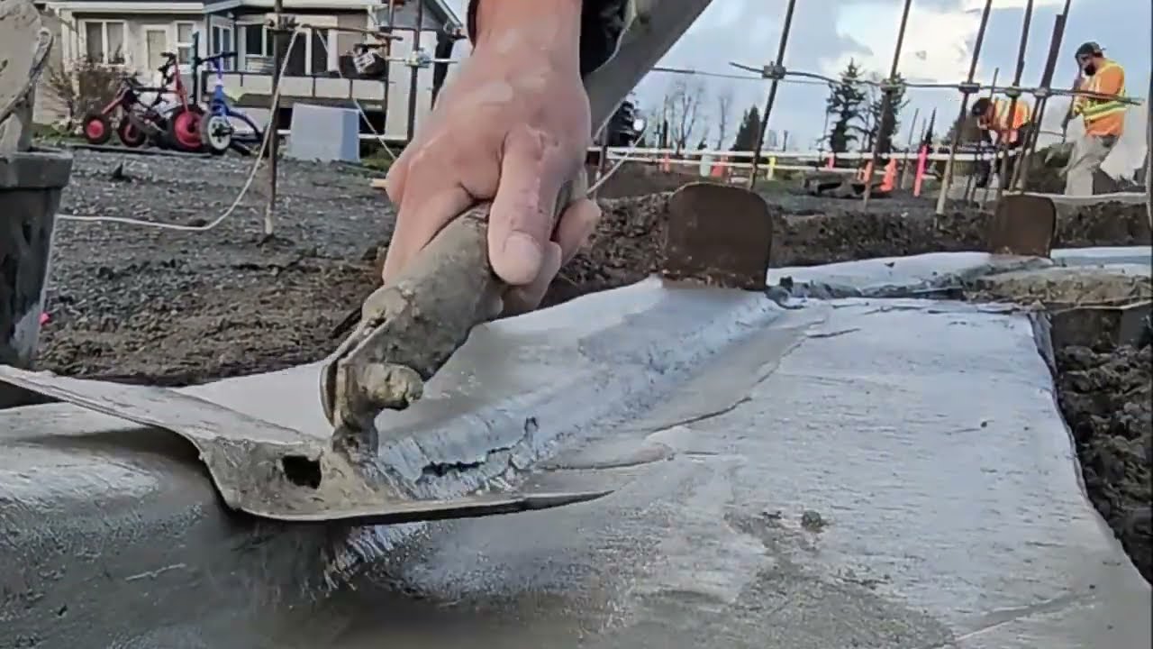 Complete installation of a Water drainage system, on a NEW CONCRETE CURB poured by a Gomaco Machine