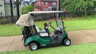 Little boy crashes golf cart into fence