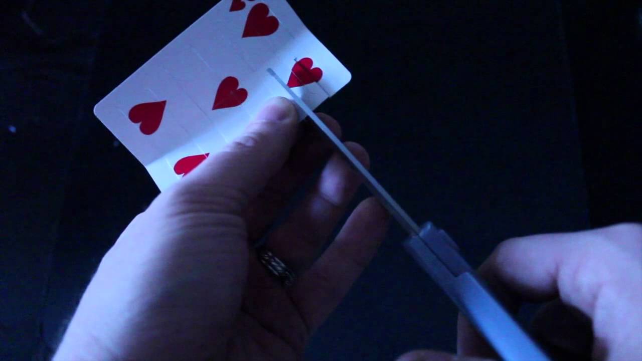 Cut a hole in a playing card big enough that your head can fit through