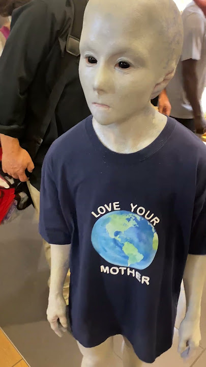 Person dressed as an alien walks around NYC mall