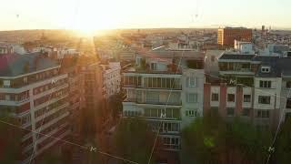 Slide and pan footage of apartment houses in town. Large city in background. View against setting screenshot 1