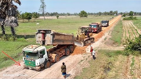 New road development project pouring red soil and paving long roads by use big dozer working fast
