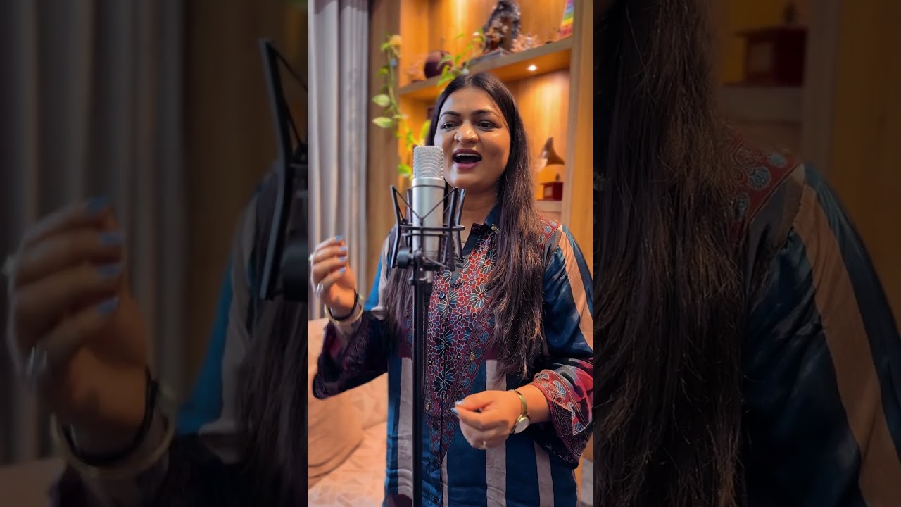 Alpa Patel singing at a studio microphone