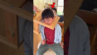 Little Boy Stuck In A Wooden Chair