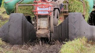 Small tractor getting pulled by harvester | Mini farming tractor getting pushed from mud