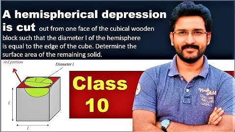 A hemispherical depression is cut out from one face of the cubical wooden block