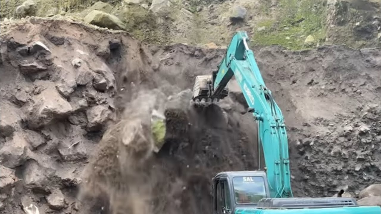 Excavators work digging sand and rock - YouTube