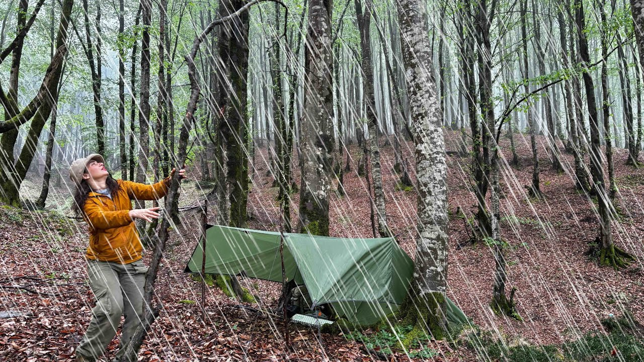 Solo girl camping in the heavy rain and fog - building shelter ...