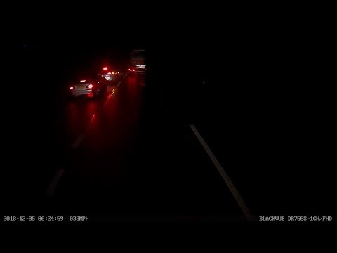 Two cars stopped and indicating at end of slip road