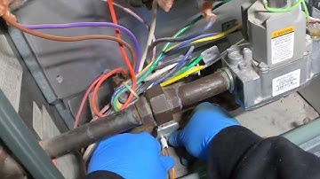 Replacing a flame sensor on a Rheem furnace.