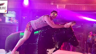 Men With Colours Glasses Riding On A Bull In Benidorm 4K