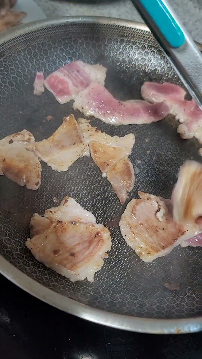 Frying meat of pork and spring onions to smooth