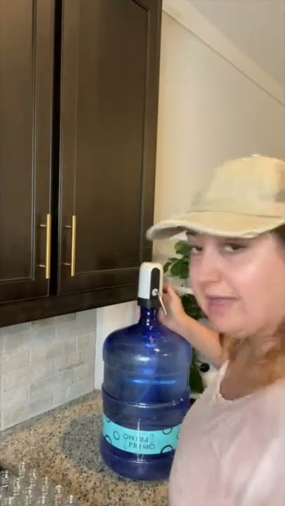Restock reusable water bottles with me using a 5 gallon water jug and an electric pump.