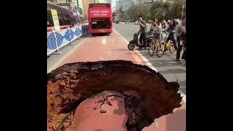 Horrific moment giant sinkhole nearly swallowed a bus carrying 21 following sudden road collapse