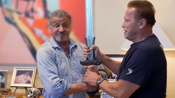 Sylvester Stallone Holds Arnold