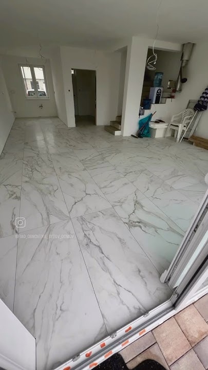 the-gluing-of-the-floor-tiles-on-the-lower-level-of-the-house-has