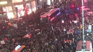 Crowds gather to protest outside Trump Tower