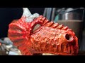 Dremel carving a dragon in found wood