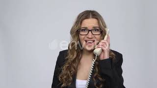 Portrait of Angry Businesswoman Shouting in White Phone on Gray Background Stock Footage - En