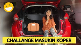 the challenge of putting a suitcase in the trunk of a car