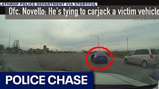 Suspect clings to car during police chase