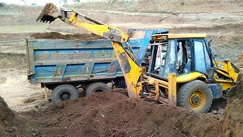 Old jcb 3dx loading mud in Tata 2518 truck