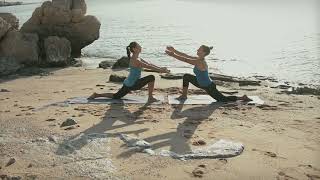 Young Women Doing Yoga On The Beach