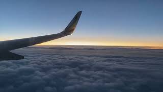 Peaceful airplane view with calming music - sunset, clouds and snowy city