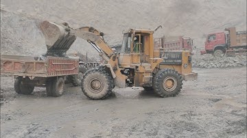 Caterpillar 966F Wheel Loader Loading Huge Rocks On Dumper Truck and Trolleys