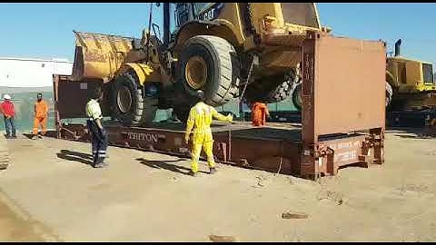 LOADING WHEEL LOADER INTO 40FT FLAT RACK SHIPPING CONTAINER